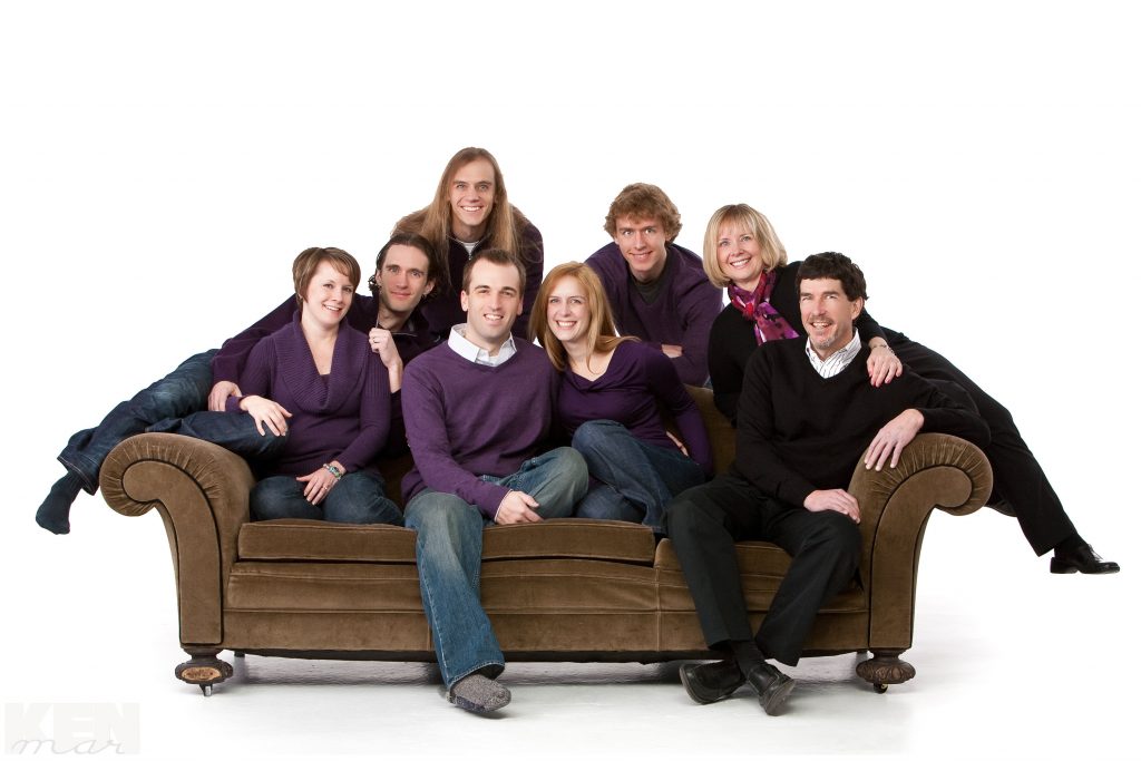 Fun, casual unposed pose of a family of 8