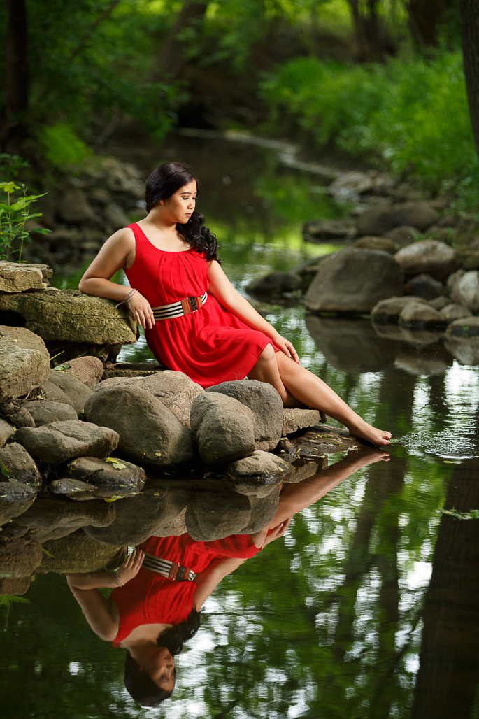 Young woman posed outdoors by stream